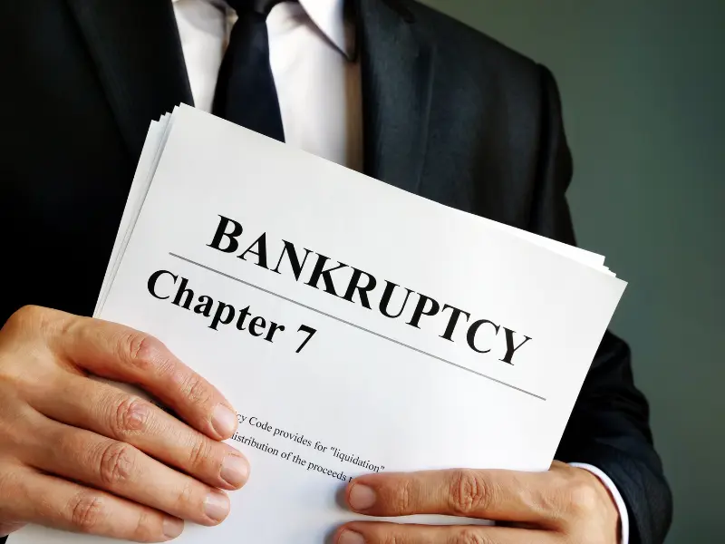 An image of a person reviewing Chapter 7 bankruptcy documents