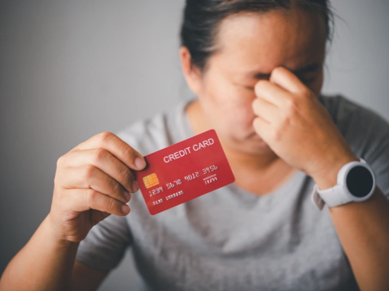 Image showing a person battling too much credit card debt.